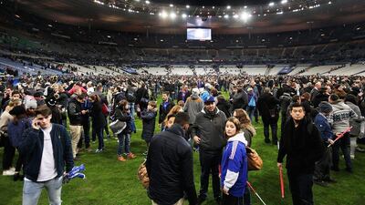 Spectators gather on the pitch after news of the bombing and terrorist attacks in Paris reaches the fans. Adam Pretty/Bongarts / Getty Images