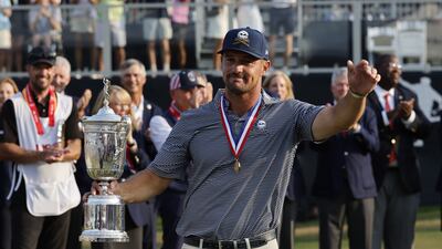 Bryson DeChambeau celebrates with the US Open trophy after winning the 2024 tournament at Pinehurst No 2. EPA