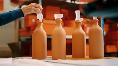 Terracota bottles are topped with crystal stoppers. Photo: Hermes