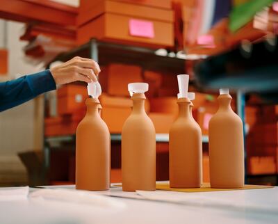 Terracota bottles are topped with crystal stoppers. Photo: Hermes
