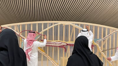 Participants at Tanween's interactive Weaving Wall. Photo: Tanween