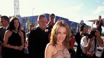 Kylie Minogue, in a brown-toned mini dress, attends the opening of Fox Studio in Sydney, Australia on November 1, 1999.