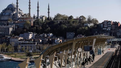 Backdropped by the iconic Suleymaniye Mosque in Istanbul, commuters wait at a metro station on a bridge over the Golden Horn in Istanbul. AP