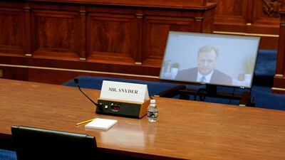 An empty seat for Washington Commanders co-owner Dan Snyder, who declined to appear, is seen as NFL commissioner Roger Goodell testifies by video. Reuters