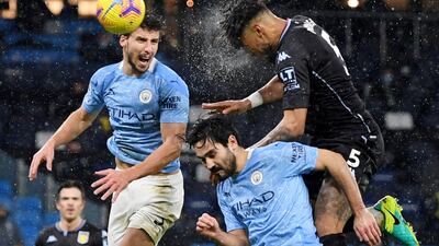 Aston Villa's Tyrone Mings in action with Manchester City's Ruben Dias and Ilkay Gundogan. Reuters