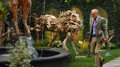 Finishing touches are made to a driftwood sculpture. This year marks the first time the event has been held in autumn. AFP