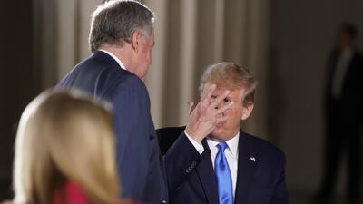 US President Donald Trump consults with White House chief of staff Mark Meadows. Reuters