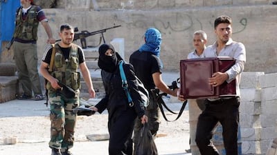 Syrian civilians carry their belongings as they flee the fighting. Bulent Kilic / AFP Photo