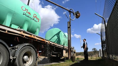 Water carrier Andrew Pearce fills his tanker with potable water at a council depot in the regional Queensland town of Stanthorpe. AFP