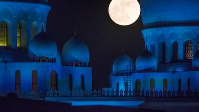 The supermoon rises behind Sheikh Zayed Grand Mosque in November 2016. Christopher Pike / The National