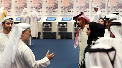 Abu Dhabi, UAE. September 24, 2011 Dr Awnar Mohammad al Gargash, Miunister of State for Foreign Affairs and Minister of State for FNC Affairs (second from left) greets some of the candidates who have arrived and are waiting and anxiously watching as votes???