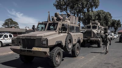 South African National Defence Force (SANDF) soldiers drive in an Armoured Personnel Carrier (APC) in the Cape Flats area of Cape Town during a patrol to enforce the 21-day nationwide lockdown in South Africa. AFP