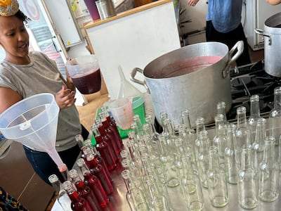 Entrepreneurs helped by the Migration Business Support programme bottle rose cordial. Photo: Maria Mohammed
