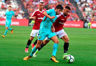 Barcelona's midfielder Sergi Roberto, left, vies with Gimnastic's defender Xavi Molina. Jose Jordan / AFP