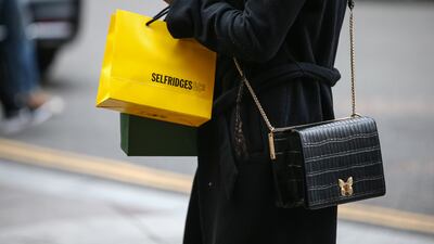 A shopper carries a shopping bag outside Harrods luxury department store on April 22, 2022 in London, England. Hollie Adams / Getty Images)