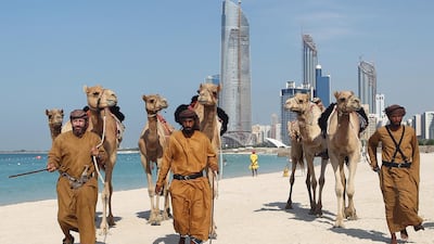 British explorer Adrian Hayes, left, and Saeed Al Mesafry, right, with Ghafan Al Jabry of the UAE armed forces, arrive at their final destination in Abu Dhabi on December 13, 2011 after completing a 44-day trek across the Empty Quarter AFP