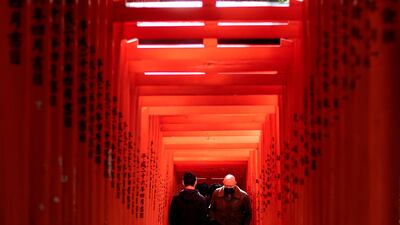 People walk along a row of gates at Hie Shrine in Tokyo. AFP