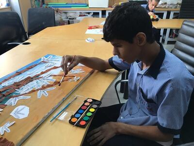 Children from Senses painting their Ghaf tree to be made into a carpet for Dubai Design Week. Courtesy Hands