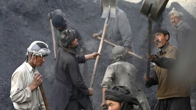 Labourers shovel coal onto a truck at a coal dump site outside Kabul. Each worker earns an average of $10 per working day, with most of them coming come from the northern provinces, leaving their families behind to find work in the capital. Mohammad Ismail / Reuters