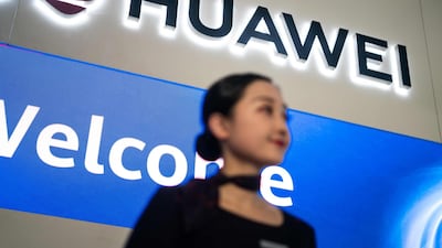 A hostess welcomes journalists and guests who attend the Huawei database and storage product launch during a press conference at the Huawei Beijing Executive Briefing Centre in Beijing. AFP
