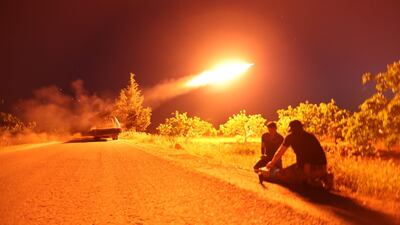 Syrian fighters from the Turkish-backed National Liberation Front (NLF) fire a missile against regime positions in the rebel-held northern part of Syria's Hama province. AFP