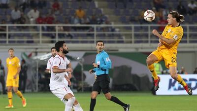 Khrbin, left, fights for the ball against Australia's Jackson Irvine. AFP