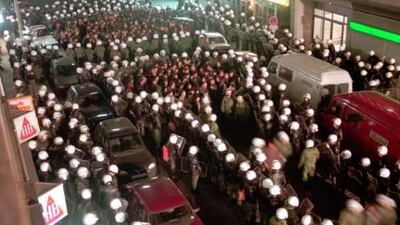German riot police have surrounded Kurdish demonstrators after a torchlight parade of about 200 Kurds in Hamburg in March 1996. The novel's narrator marries a young Kurdish man to keep him from being deported from Germany. AP Photo