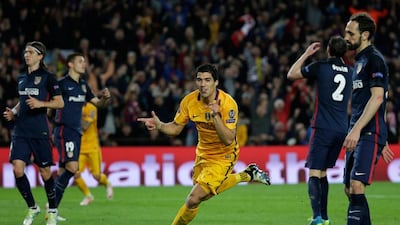 Barcelona's Luis Suarez celebrates after scoring his side’s second goal during a Champions League quarter-final, first leg soccer match between FC Barcelona and Atletico Madrid at the Camp Nou stadium in Barcelona, Spain, Tuesday April 5, 2016. (AP Photo/Emilio Morenatti)