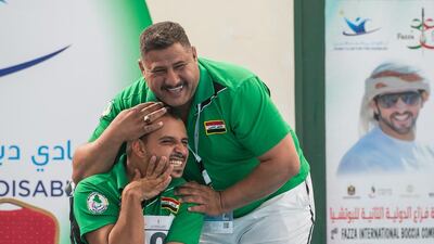 Mohamed Fadhel Jiad of Iraq embraces his coach after winning the BC1 bronze medal match at the Fazza International Boccia Competition. Photo Courtesy / HHC Media