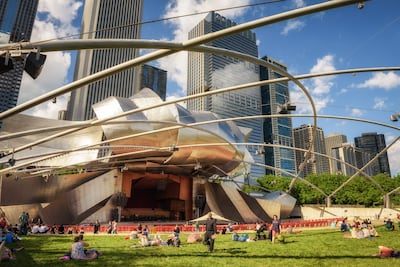 The stage at the open-air Jay Pritzker Pavilion is framed by curved stainless steel ribbons. Getty Images
