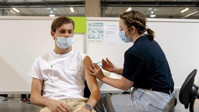 A GGD employee administers the Janssen vaccine to a man at a vaccination center in Nieuwegein. EPA