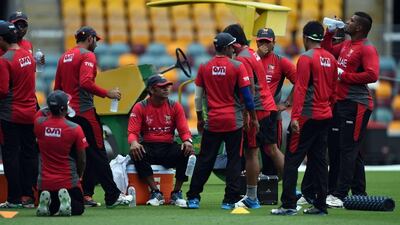 Aaqib Javed, sitting, has been instrumental in the recent success of the UAE cricket team. Indranil Mukherjee / AFP