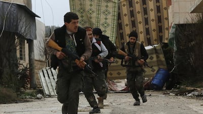 Rebel fighters of al-Jabha al-Shamiya (the Shamiya Front) run with their weapons to avoid snipers, north of Handarat camp in Aleppo, after the group said they took control of the area from forces loyal to Syria's President Bashar Al Assad earlier this year. Hosam Katan / Reuters