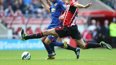 Sunderland defender Santiago Vergini, right, tackles with Manchester United striker Robin van Persie. AFP