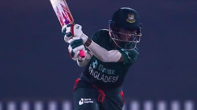 Murshida Khatum, left, plays a shot.