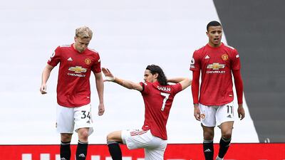 Edinson Cavani, centre, celebrates scoring United's third goal. PA