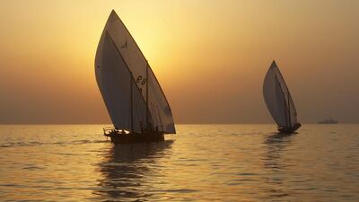 Traditional wooden boats, or dhows, compete at sunrise during the Al Gaffal race, a long-distance dhow sailing race, near Sir Bu Nuayr, near Sharja. Martin Dokoupi / Reuters