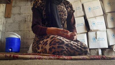 A Yazidi girl, 15, captured by ISIS and forcibly married to a militant in Syria, sits on the floor of a one-room house she now shares with her family. AP