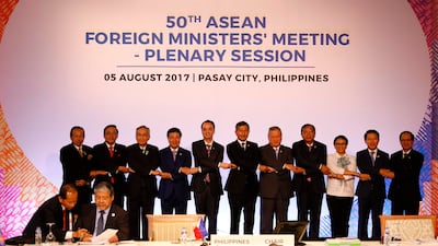 Officials link arms as they pose before a meeting of the 50th Association of Southeast Asian Nations (ASEAN) Foreign Ministers Meeting at the Philippine International Convention Center in Manila on August 5, 2017. AFP / Erik De Castro