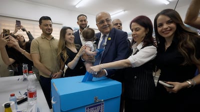 Ahmad Tibi, leader of the Arab Movement for Change party, casts his ballot in Tayibe, Israel. EPA