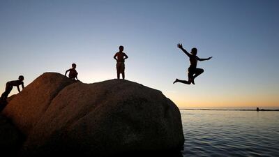Children leap into a tidal pool as temperatures soar at Camps Bay beach in Cape Town, South Africa. Mike Hutchings / Reuters