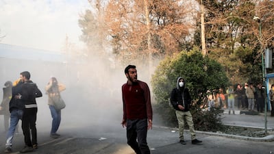 University students attend a protest inside Tehran University while a smoke grenade is thrown by anti-riot Iranian police. Ten people have been killed so far according to Iranian state television. AP