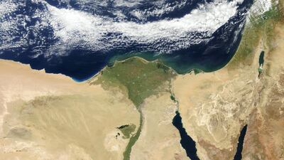 A satellite view of Cairo, Egypt, and the valley of the Nile River. The triangular Nile Delta appears green. Getty Images