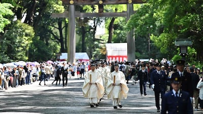 Shinto priests walk towards the main building to conduct a festive ceremony to report the enthronement of the new emperor to the royal family's ancesters at Meiji Shrine in Tokyo. Japan's new Emperor Naruhito formally ascended the Chrysanthemum Throne, a day after his father abdicated from the world's oldest monarchy and ushered in a new imperial era. AFP