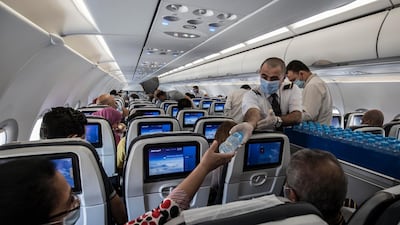 Egyptian cabin crew wearing masks and gloves are pictured in a domestic flight at Cairo airport. AFP