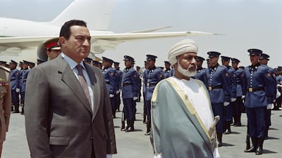 Egytian President Hosni Mubarak and Oman's Sultan Qaboos bin Said review the honor guard, on June 22, 1992 at Alexandria. AFP