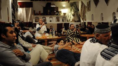 Guests and visitors at the Maison Traditionelle Akham, a popular hotel on the edge of Ghardaia, watch local musicians perform. Lindsay Mackenzie for The National.