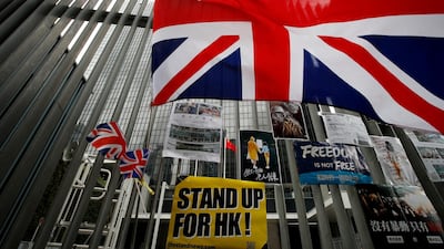 British flags flutter next to protest placards placed by protesters outside the Central Government Office building in Hong Kong on Thursday. Andy Wong