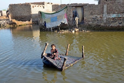 A Pakistani girl crosses a flooded street in the Jaffarabad district of Balochistan province last month. The country recently experienced its worst floods in more than a decade. AFP