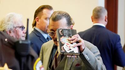 Depp looks toward the courtroom gallery as they take a break. Reuters